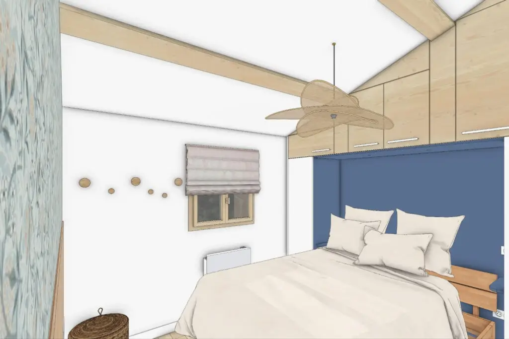 Chambre rénovée avec dressing et tête de lit bleue à Zonza